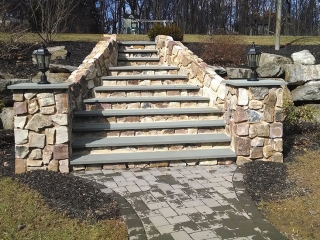 ornate outdoor stone steps with landscape lighting