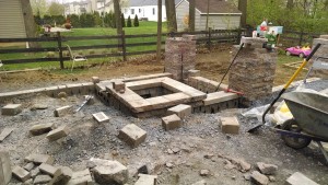 custom square fire pit in beginning stage of construction