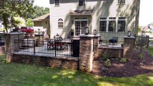 retaining walls with landscape lighting and aluminum fencing