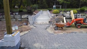 hardscaping crew installing stonework to concrete steps