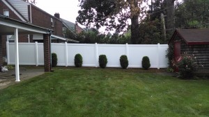 large white vinyl fencing bordering the lawn